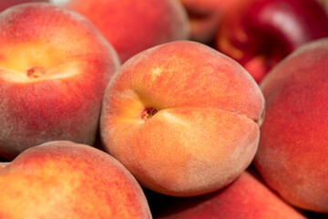 Ripe and juicy peaches in a box