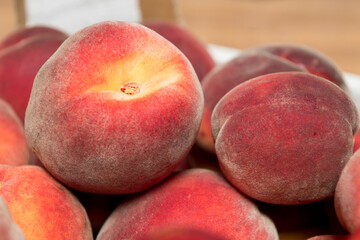 Ripe and juicy peaches in a box