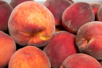Ripe and juicy peaches in a box