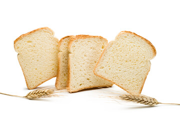 Slices of white bread with ears of wheat on white background.