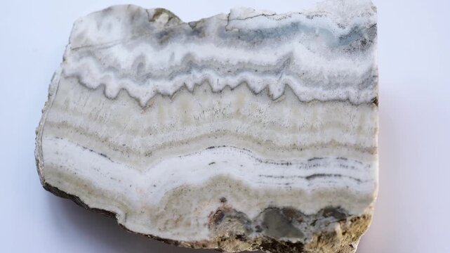 An agate sample on a white background. An unprocessed sample of the mineral agate is spinning 3d on a white background.
