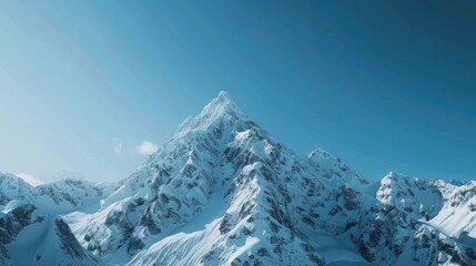A majestic mountain peak covered in snow under a clear sky.