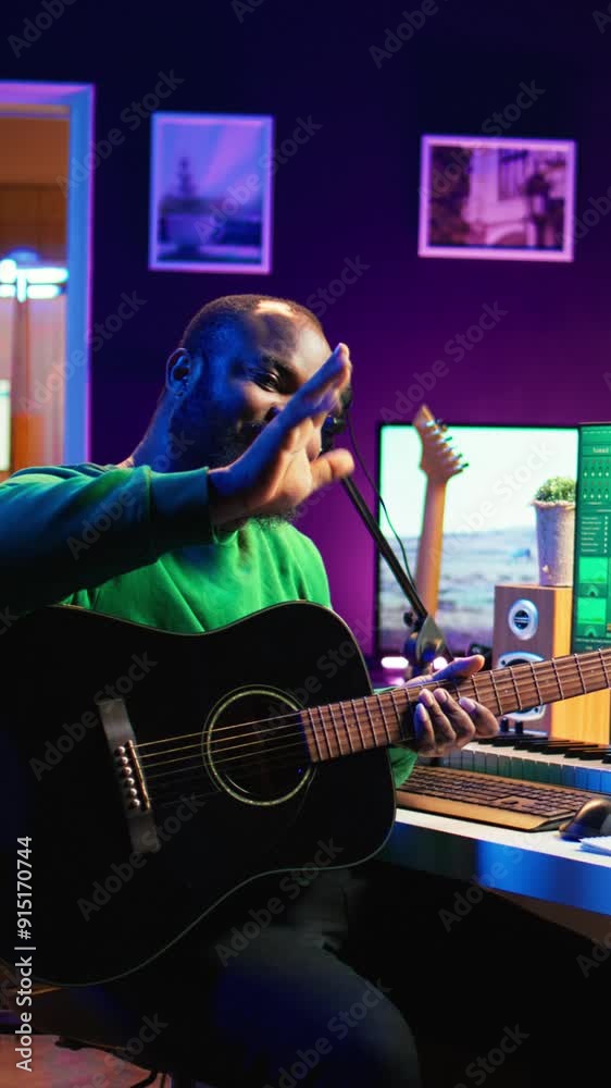 Poster Vertical Video Professional composer teaching guitar lessons online on master class, recording himself playing acoustic instrument accords and explaining notes for tutorial. Young musician making