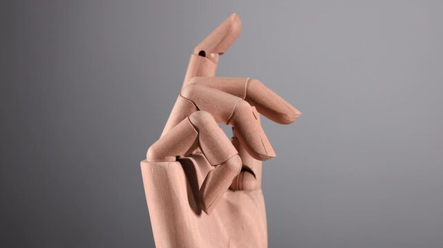 Wooden hand rotating as if on display.