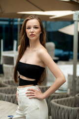  beautiful stylish fashion woman posing near modern building