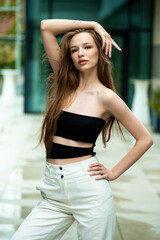  beautiful stylish fashion woman posing near modern building