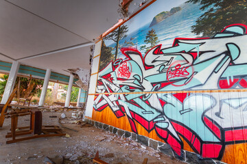 Graffiti on the wall of a vandalized room of an abandoned hotel. Abandoned hotel. Hotel Neptuno....