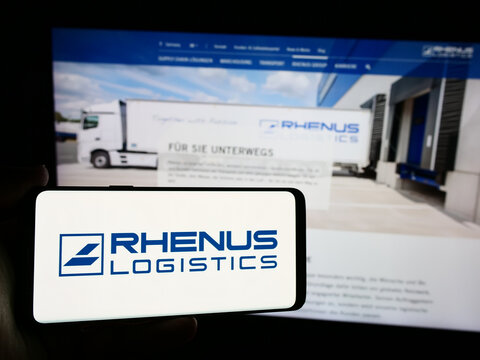 Stuttgart, Germany - 08-01-2024: Person holding smartphone with logo of German logistics company Rhenus SE Co. KG in front of website. Focus on phone display.