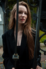 young beautiful woman posing on the street formal modern clothes. beautiful fashionable girl posing in the street