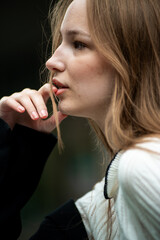Young woman with long hair black jacket and white trousers street style