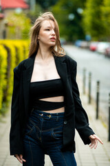 young beautiful woman posing on the street formal modern clothes. beautiful fashionable girl posing in the street