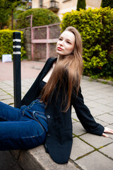 young beautiful woman posing on the street formal modern clothes. beautiful fashionable girl posing in the street