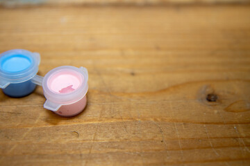 a selection of children's small paint pods on a wooden table