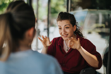 Two young business associates are having a lively conversation outdoors, conveying engagement and...