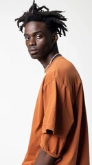 Obraz premium A man with dreadlocks is wearing a brown shirt