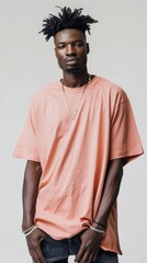 Obraz premium A man with a shaved head and a necklace is wearing a pink shirt