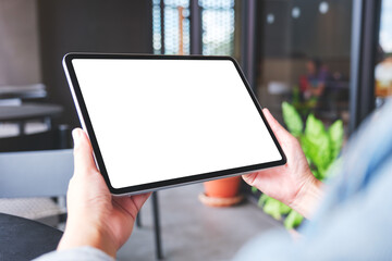 Mockup image of a woman holding digital tablet with blank white desktop screen