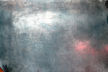 Grunge aluminum plate. Cool glossy metal surface. Design background. Reflection blue and pink. Copy space.