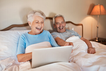 Senior, couple and laughing with laptop in bedroom for social media, browsing internet and watch...