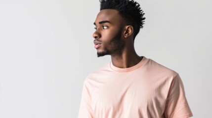 Obraz premium A man with a shaved head and a beard is wearing a pink shirt