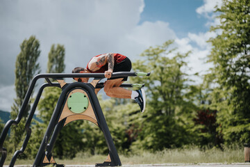 A sports enthusiast performs challenging fitness routines on modern outdoor gym equipment,...