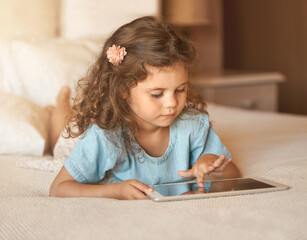 Home, internet and child with tablet on bed for fun, brain development and online educational video. Relax, kid and girl with tech in house for cognitive growth, learning and sensory entertainment