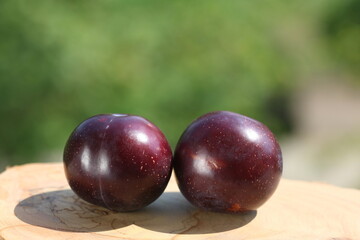 plums on a wooden background