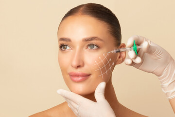 Beauty injections. Lifting lines on young woman's face showing skin tightening and face contour...