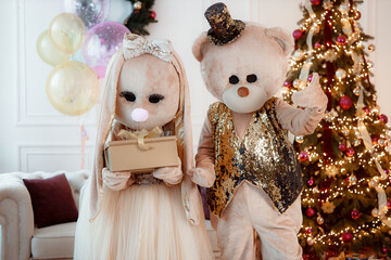 Happy new year 2025. Background for Christmas and New Year holidays. The teddy bear and rabbit bring a present for the new year. Winter vacation.
