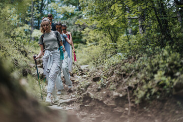 Group of friends hiking on a forest trail, enjoying nature, fresh air, and outdoor adventure. Perfect for concepts of friendship, fitness, and nature exploration.