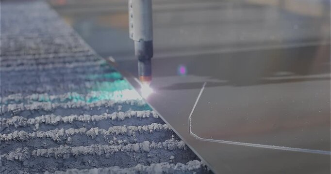 A plasma cutter cuts a detail, close-up. The work of the CNC plasma cutter. The work of a plasma cutter close-up.