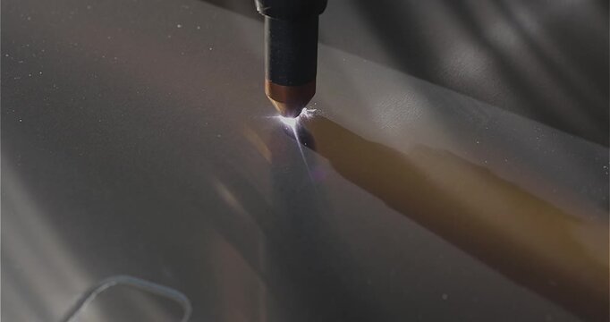 The process of cutting a metal part with a plasma cutter. Plasma cutting. Plasma cutter work at the factory. The plasma cutter will cut the part.