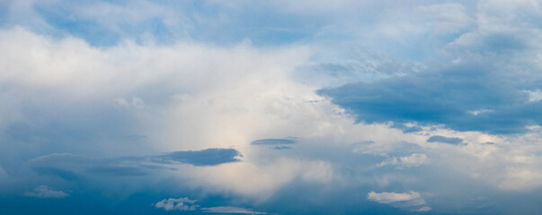 Blue sky with various clouds in soft sunlight