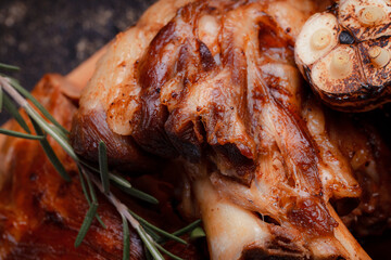 A set dish: a large fried piece of meat on the bone, country-style grilled potatoes, a mini salad of cabbage, bean sprouts, chia seeds and green onions. Original serving on a wooden cutting board.