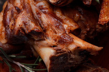 A set dish: a large fried piece of meat on the bone, country-style grilled potatoes, a mini salad of cabbage, bean sprouts, chia seeds and green onions. Original serving on a wooden cutting board.