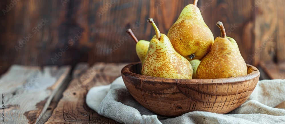Poster ripe pears in a bowl on a wooden table. with copy space image. place for adding text or design