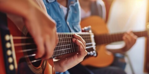 Obraz premium Close-up of fingers playing acoustic guitar.