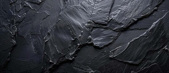 Blank black slate board against a black background copy space