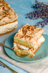 Norwegian cake. With meringue, whipped cream and almonds. Light background.
