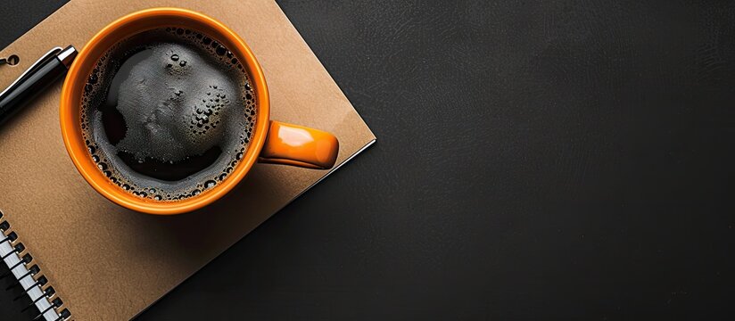 Strong coffee in the morning alongside a note reading Hello on a black background with room for text Flat lay. with copy space image. Place for adding text or design