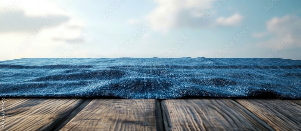 Poster blue tablecloth laid over a wooden table. with copy space image. place for adding text or design