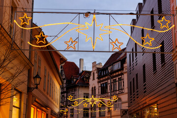 Charming Quedlinburg town evening street view illuminated with Christmas lights garlands...