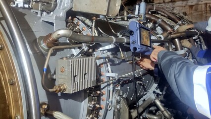 Fototapeta premium Technician performs detailed endoscopic examination of turbine inner casing, searching signs of corrosion and structural weakness. inspection is key to maintaining turbine safety standards. 