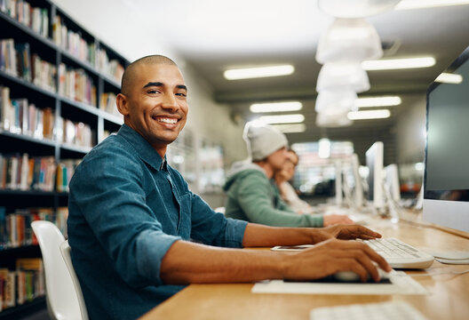 Student, computer and study in college library for programming test, project and online exam. Black man, school and portrait in university for education, learning and information technology course