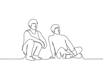 men sitting on the floor looking in one direction - one line art vector. concept male friends watching tv together or students on the grass