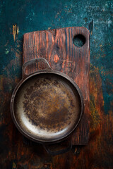 Metal cast iron pan on a wooden table. Free space for text. Top view.