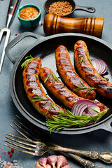 Pan with baked beef sausages. Homemade food. Barbecue or grill menu.