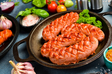 Fried chicken sausages. On a gray stone background. Top view.