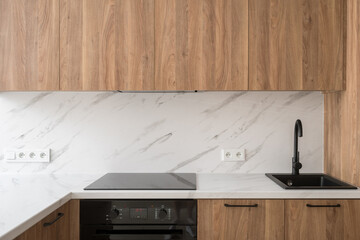 Modern kitchen countertop with black sink and stove top