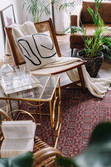 Cozy living room with rattan chair, gold and glass side table